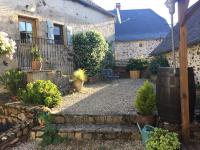 a garden in front of a house with plants at Gîte Maison Maitri in Forgès