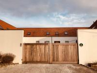 a garage with two gates and a house at Familie &amp; Vriendenwoning met fantastisch uitzicht in Ellezelles