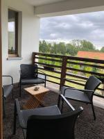 a balcony with chairs and a table and a window at Familie &amp; Vriendenwoning met fantastisch uitzicht in Ellezelles