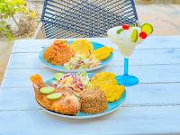 two plates of food and a drink on a table at Hotel Palma Grande by Stanza in Coveñas