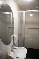a bathroom with a sink and a shower with a mirror at Nomads St Kilda in Melbourne