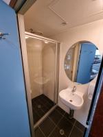 a bathroom with a sink and a mirror at Nomads St Kilda in Melbourne