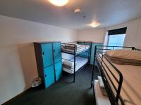 a dorm room with two bunk beds and a window at Nomads St Kilda in Melbourne