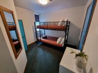 a room with two bunk beds in a room at Nomads St Kilda in Melbourne