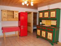 a red refrigerator in a kitchen with a table at Spacious holiday home near center of Champagny in Le Villard