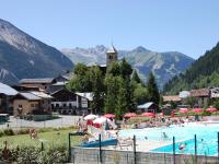 a large swimming pool with people in a resort at Spacious holiday home near center of Champagny in Le Villard