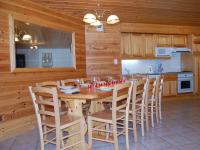 a dining room with a table and chairs in a kitchen at Spacious holiday home near center of Champagny in Le Villard