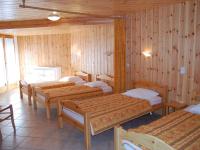 a room with four beds and wooden walls at Spacious holiday home near center of Champagny in Le Villard
