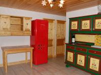 a kitchen with a red refrigerator and a table at Spacious holiday home near center of Champagny in Le Villard