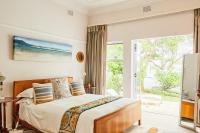 a bedroom with a bed and a sliding glass door at Maison Jacaranda in Johannesburg