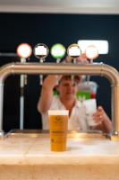 a person taking a picture in a mirror with a cup at Vila Gale Nautico in Armação de Pêra