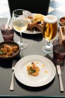 a table with plates of food and glasses of wine at Vila Gale Nautico in Armação de Pêra