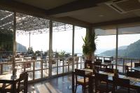 a restaurant with tables and chairs and windows at Loryma Resort Hotel in Turunc