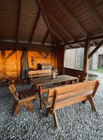 a cabin with wooden tables and chairs in it at Apfelhof Biesenbrow in Biesenbrow