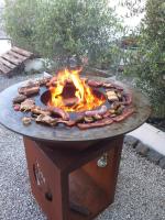 a fire pit with some food on top of it at Familie &amp; Vriendenwoning met fantastisch uitzicht in Ellezelles