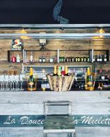 a bar with a wooden counter with a bar stool at Familie &amp; Vriendenwoning met fantastisch uitzicht in Ellezelles