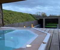 a hot tub sitting on top of a wooden deck at Familie &amp; Vriendenwoning met fantastisch uitzicht in Ellezelles
