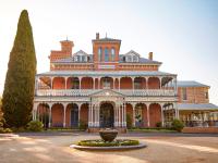 a large red brick building with a vase in front of it at Duntryleague in Orange
