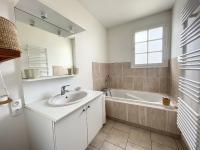 a bathroom with a sink and a bath tub at Maison Saint-Pair-sur-Mer, 5 pièces, 8 personnes - FR-1-361-56 in Saint-Pair-sur-Mer