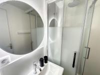 a white bathroom with a sink and a mirror at Studio Granville, 1 pièce, 2 personnes - FR-1-361-526 in Granville