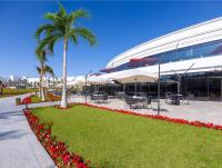 a palm tree and flowers in front of a building at Rixos Radamis Sharm El Sheikh in Sharm El Sheikh