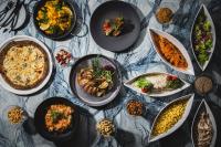 a table with many plates of food on it at SAPPORO STREAM HOTEL in Sapporo