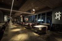 a restaurant with tables and chairs and windows at SAPPORO STREAM HOTEL in Sapporo