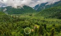 an aerial view of a village in a mountain valley at Holiday house Kajfes in Brod na Kupi