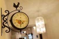 a clock with a rooster on it next to a lamp at EZE Homestay in Ji&#39;an