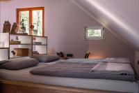 a bedroom with two beds and a window at Holiday house Kajfes in Brod na Kupi