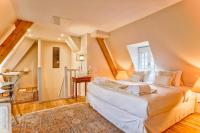 a bedroom with a large bed and a staircase at Le Grand Galop - Duplex in Deauville
