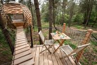 a gazebo with a table and chairs on a wooden deck at Dihan Evasion in Ploemel