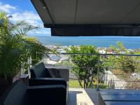 a balcony with chairs and a view of the ocean at studio Les Alysées in Saint-Pierre
