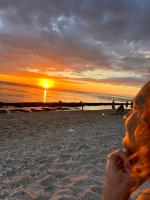 a person watching the sunset on the beach at studio Les Alysées in Saint-Pierre