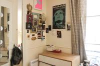 a room with a desk and posters on the wall at Apartment near the Marais in Paris