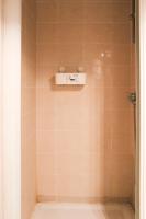 a bathroom with a shower with a scale on the wall at Apartment near the Marais in Paris