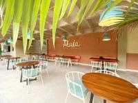 a restaurant with tables and chairs in a cafeteria at Trip Monkey del Río in San Gil