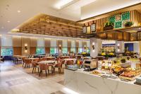 a restaurant with tables and chairs and a buffet at voco Chiayi by IHG in Chiayi City