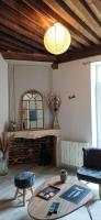 a living room with a table and a fireplace at La Maison du Bonheur - Logement entier de 39 m2 in Bourg-en-Bresse