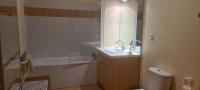 a bathroom with a sink and a tub and a toilet at Le Porteur de Glace Classé 2 étoiles in Aulus-les-Bains