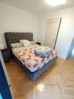 a bedroom with a bed with a quilt on it at BEAU APPARTEMENT in Suresnes