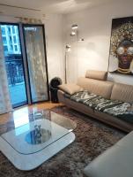 a living room with a couch and a glass table at BEAU APPARTEMENT in Suresnes