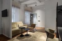 a living room with a couch and a table and chairs at Konventa Sēta Hotel Keystone Collection in Riga
