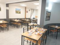 a dining room filled with tables and chairs at Résidence L&#39;Ogomé in Le Boupère