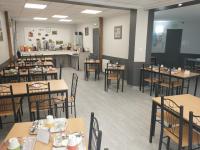 an empty dining room with tables and chairs at Résidence L&#39;Ogomé in Le Boupère