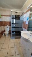 a bathroom with a glass shower and a toilet at Résidence L&#39;Ogomé in Le Boupère