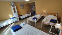 a hospital room with three beds and a table at Résidence L&#39;Ogomé in Le Boupère