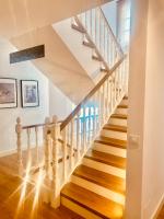a staircase with white railings and wood floors at Hostal La Janda in Vejer de la Frontera
