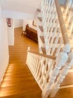 a staircase in a house with wooden floors at Hostal La Janda in Vejer de la Frontera