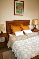 a bedroom with a large bed with two pillows at Le Clos des Laurons in Nyons